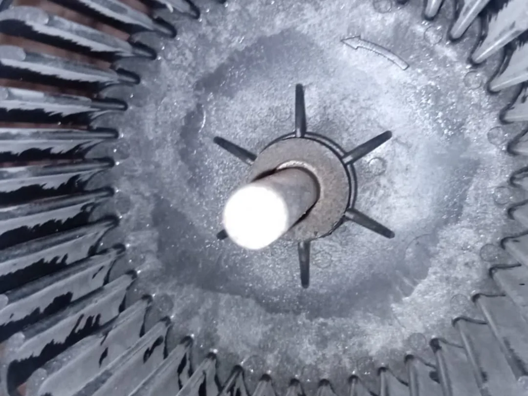 After cleaning: the same blower wheel with the blades and hub stripped back to bare metal.