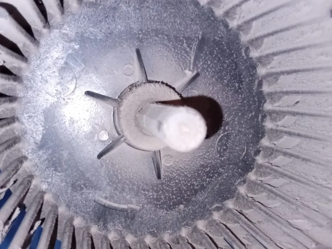 Before cleaning: a blower wheel with dust caked between its blades and around the hub.