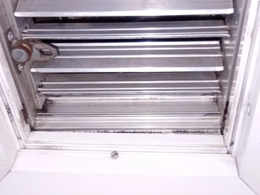 After cleaning: the same coil with the fins washed clear, the gaps between them open again.
