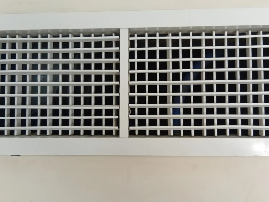 After cleaning: the same supply grille with the core washed clean and the airflow path clear.