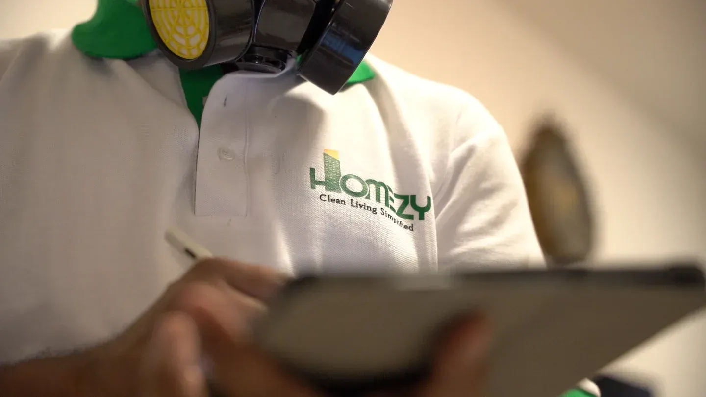 Close-up of a Homezy technician holding a dust-clogged AC filter removed from a Dubai apartment.